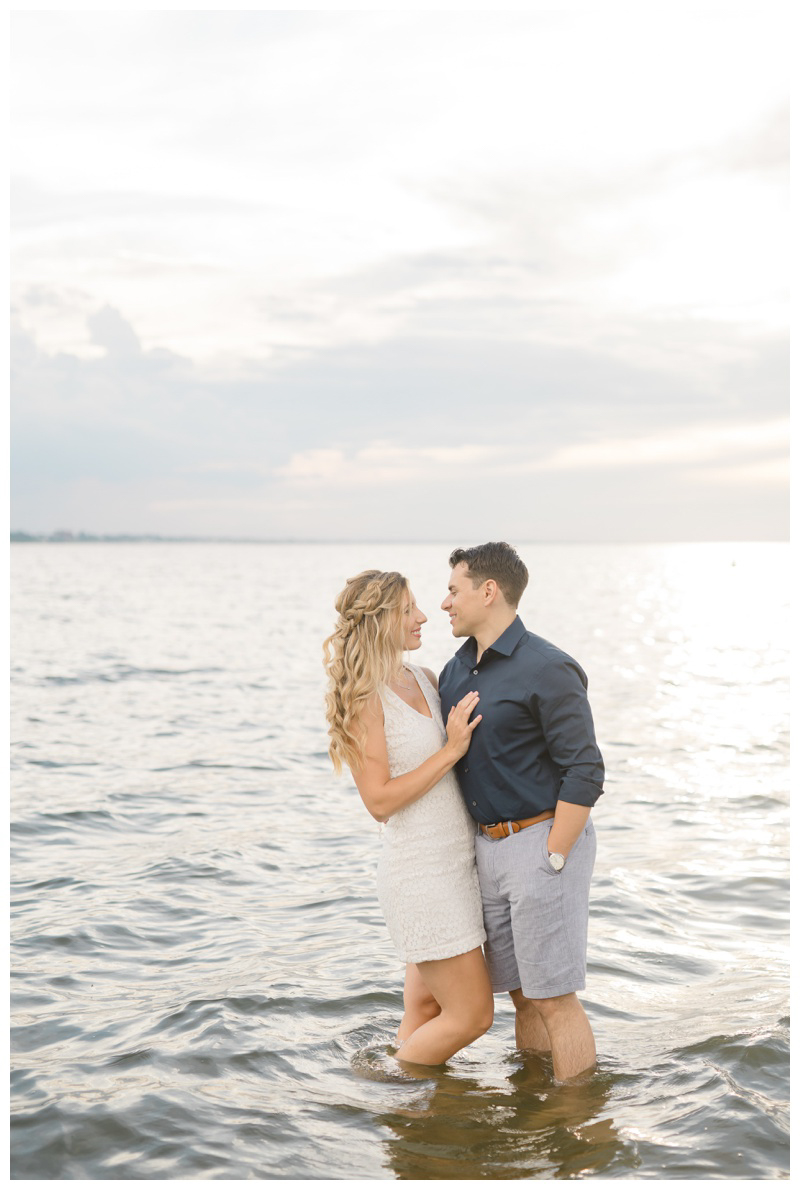 Couple in water during beach engagement photos in NJ by NJ wedding photographer Karina Mekel, couple in ocean, engagement photos in ocean